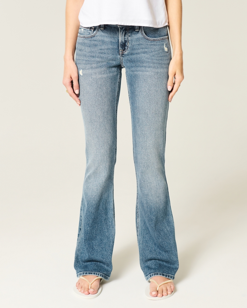 hüftig geschnittene leicht abgenutzte bootcut-jeans in mittlerer waschung