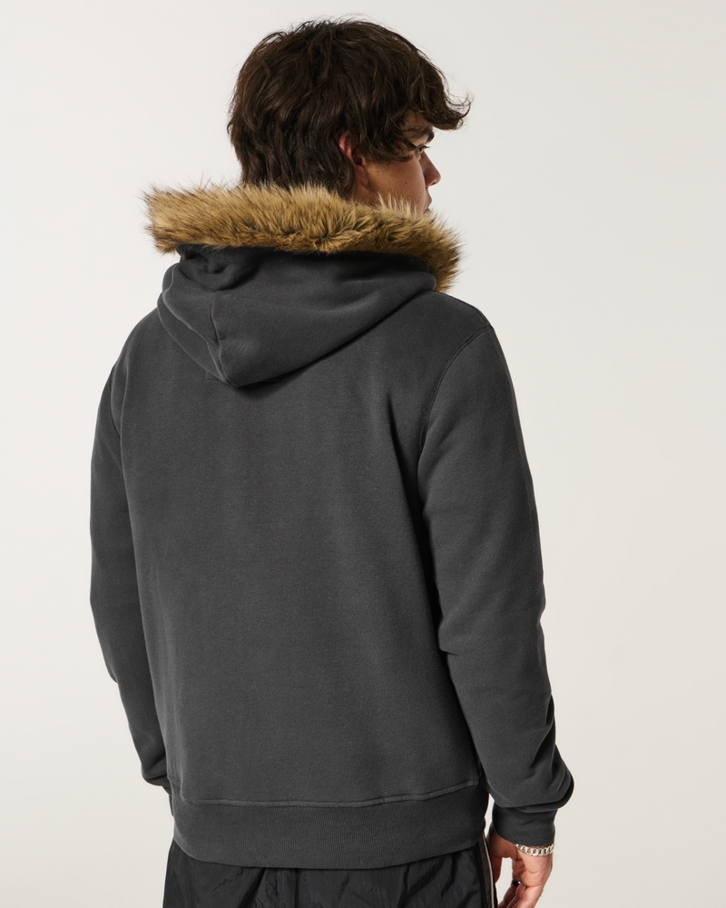 kapuzenpullover aus wildleder mit reißverschluss und kunstpelzbesatz sowie großem sonnenmuster